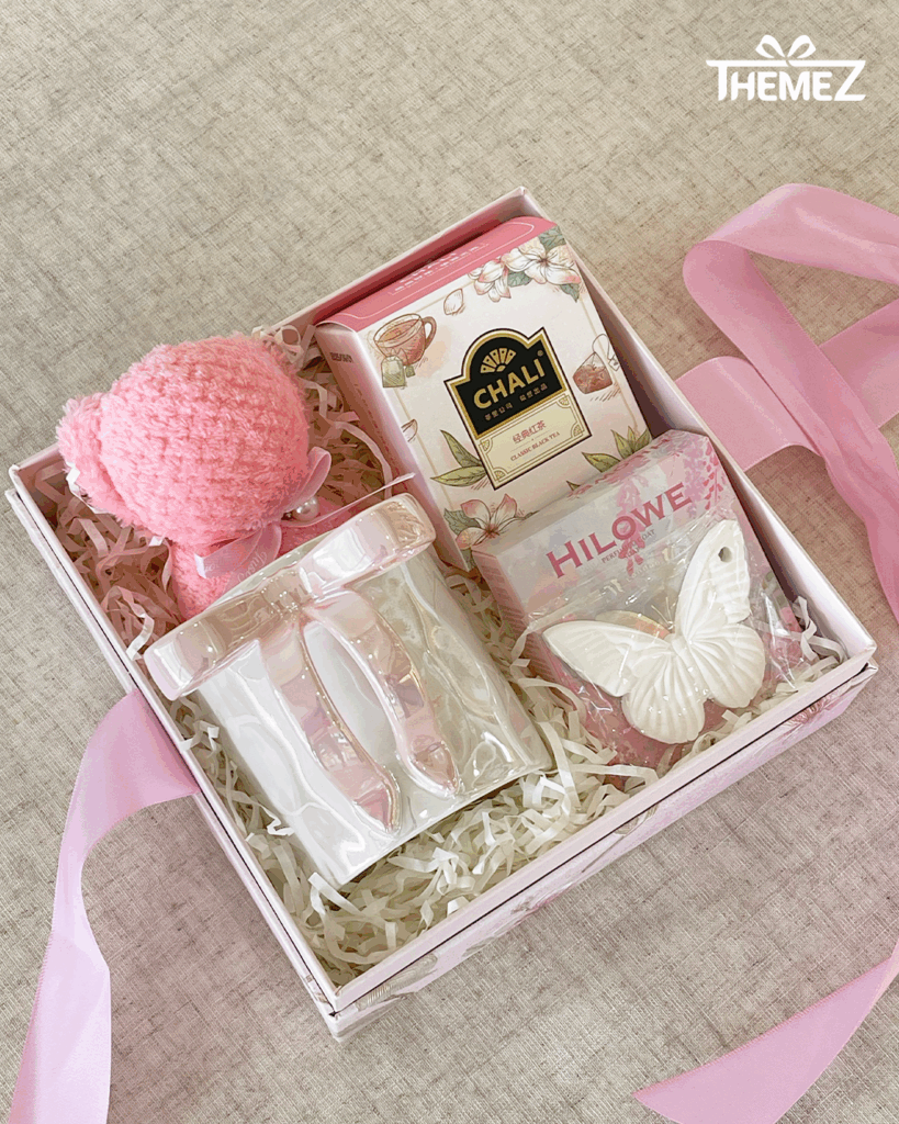 Gift box with pink-themed items